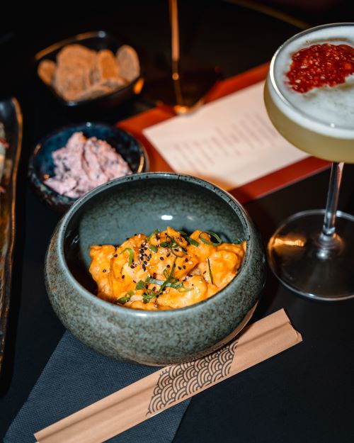 Cocktails and bites on a bar table