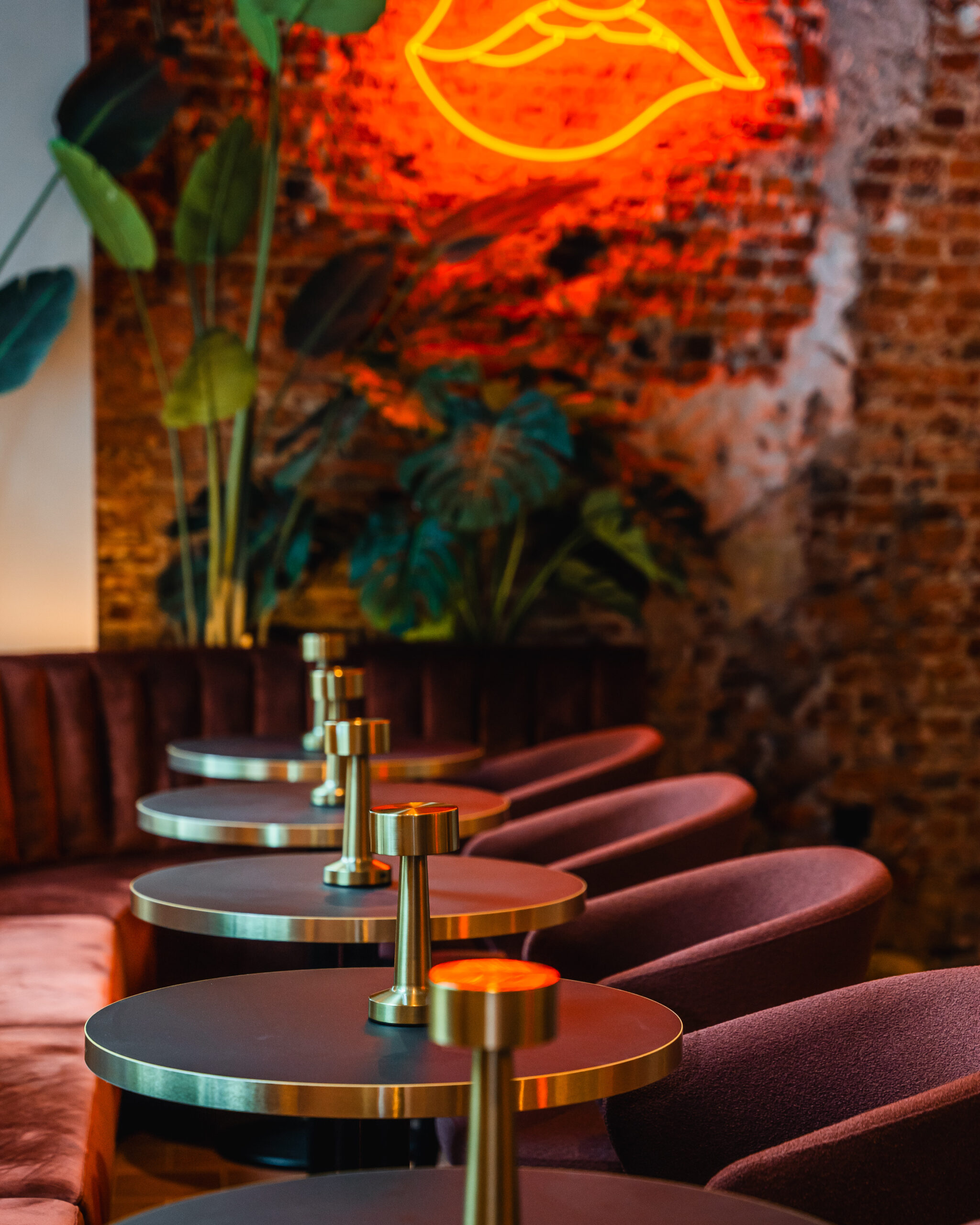 Beautiful bar interior with tables and chairs and red light wall decoration